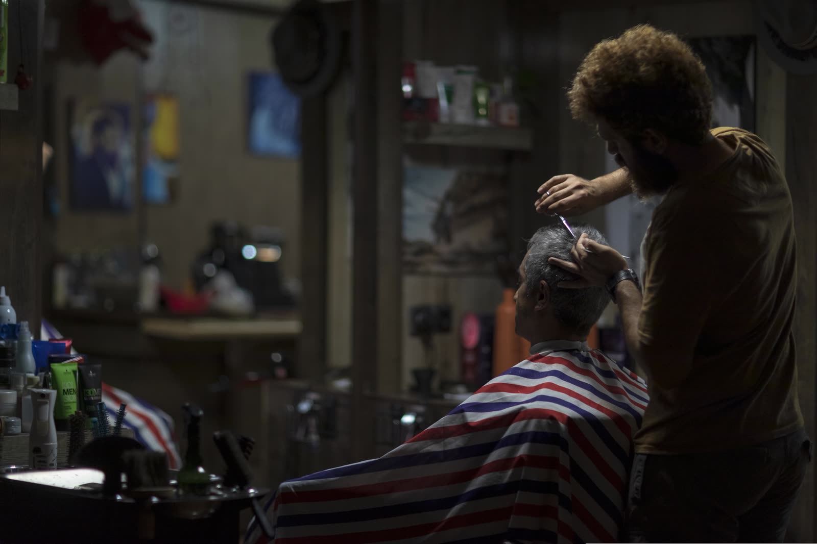 Barber working with a client